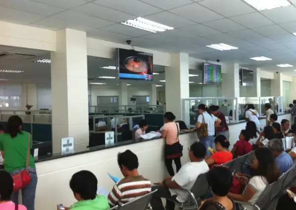 People inside an office in the Philippines paying taxes using withholding tax. 