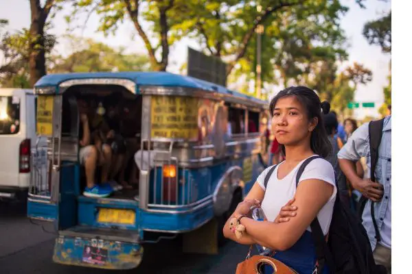 Young Filipino woman waiting for a jeepney to come